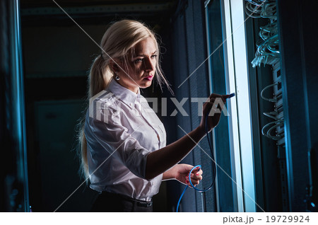 Young engineer businesswoman in server room Young engineer businesswoman in server room 19729924