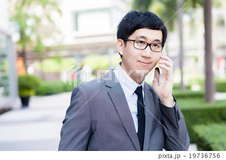 Young Asian businessman talking on the phone 19736756