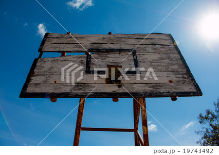 Basketball hoop is broken and wood board damaged Basketball hoop is broken and wood board damaged 19743492