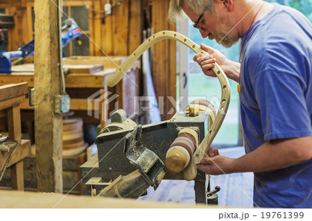 Carpenter polishing wood with sander Carpenter polishing wood with sander 19761399