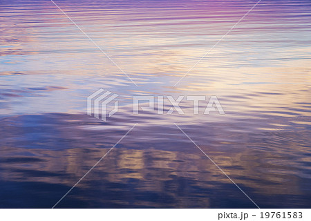 Rippled water reflecting colorful light 19761583