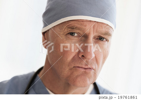 Portrait of surgeon in scrubs and surgical cap Portrait of surgeon in scrubs and surgical cap 19761861