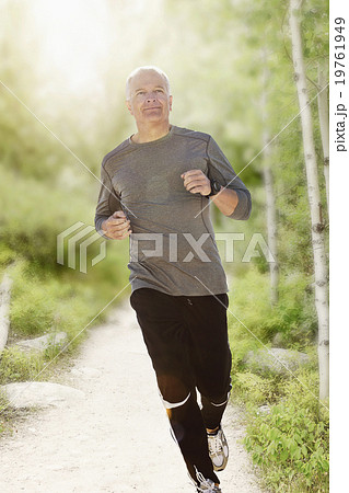 Man jogging on path in park Man jogging on path in park 19761949