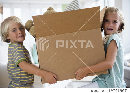 Boy (4-5) and girl (6-7) holding box 19761967