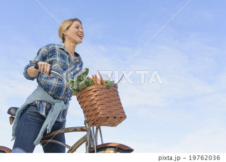 Portrait of young woman with bicycle 19762036
