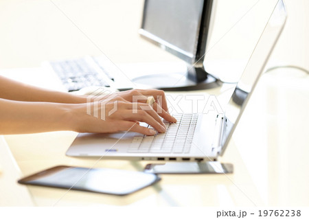 Hands typing on laptop keyboard 19762238