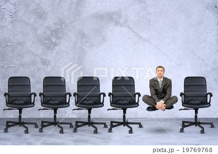 Businessman in lotus posture 19769768