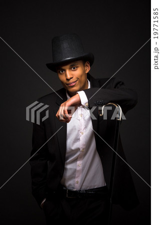 Handsome man in top hat posing with cane 19771585