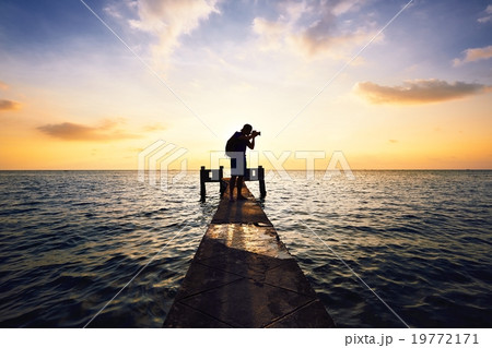 Photographer at the sunset Photographer at the sunset 19772171