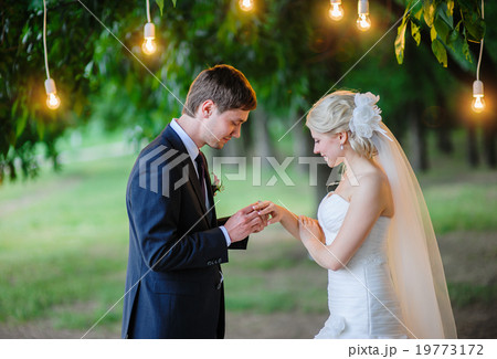 groom wears the ring bride under the arch groom wears the ring bride under the arch 19773172