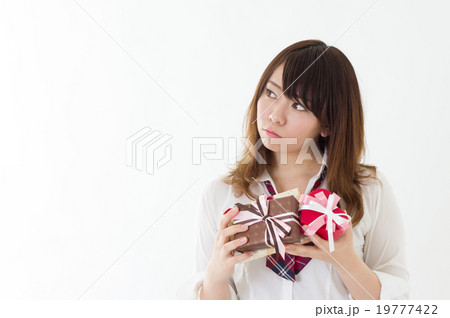 プレゼントを送る相手を思う女子高校生　用意　迷う　学生　イベント　イメージ　プレゼント正面 19777422