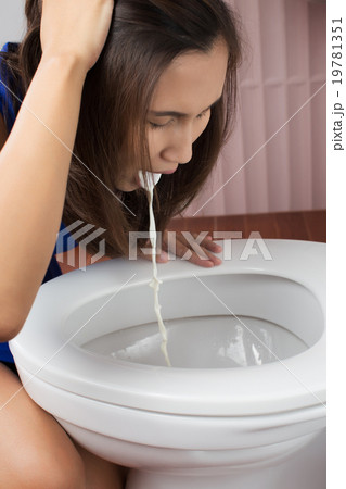 Beautiful adult woman vomiting in toilet 19781351