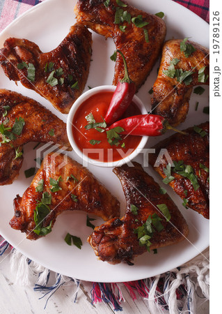 grilled chicken wings with chili sauce on a plate  grilled chicken wings with chili sauce on a plate  19789126