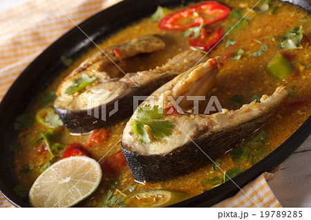 Fish curry with vegetables close-up on a plate Fish curry with vegetables close-up on a plate 19789285