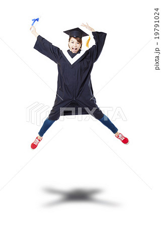 Happy female student in graduate robe jumping against white back 19791024
