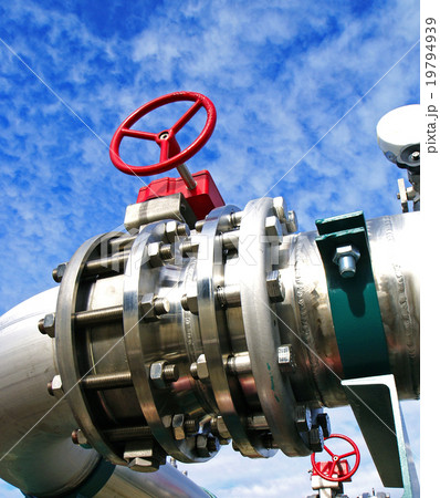 Steel pipelines and valves against blue sky 19794939