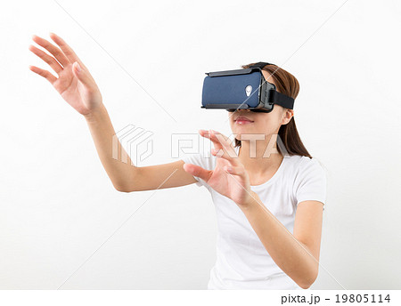 Asian woman using the virtual reality headset and two hand touch Asian woman using the virtual reality headset and two hand touch 19805114