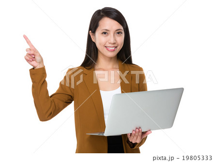 Businesswoman hold with laptop and finger point up Businesswoman hold with laptop and finger point up 19805333