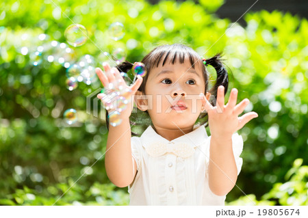 Lovely girl want to catch with the bubble Lovely girl want to catch with the bubble 19805674