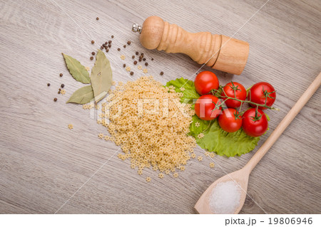Pasta, tomatoes and pepper on a wooden background 19806946