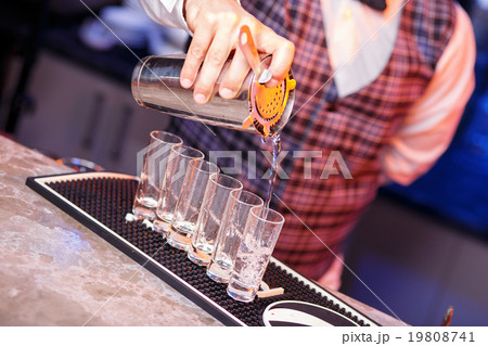 Barman at work, preparing cocktails. 19808741