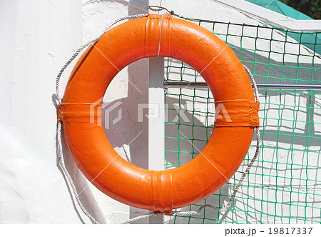 Orange lifebuoy on white ship board. Orange lifebuoy on white ship board. 19817337
