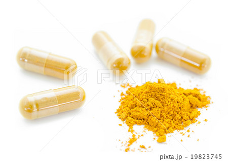 Turmeric powder and herbal capsules. Turmeric powder and herbal capsules. 19823745