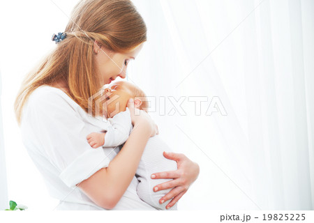 newborn baby in tender embrace of mother 19825225