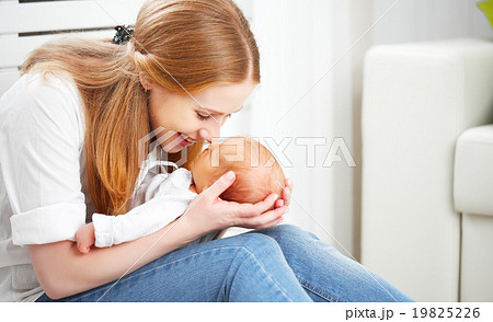 happy family. mother plays with newborn baby 19825226