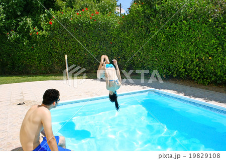 Woman jumping to swimming pool Woman jumping to swimming pool 19829108
