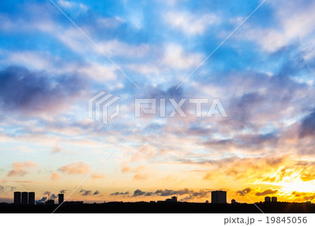 sunset sky with clouds over urban houses in winter sunset sky with clouds over urban houses in winter 19845056