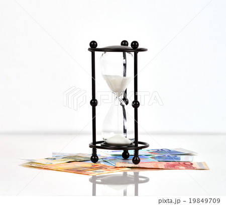 hourglass and euro banknotes 19849709