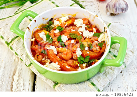 Shrimp and tomatoes with feta in green pan Shrimp and tomatoes with feta in green pan 19856423