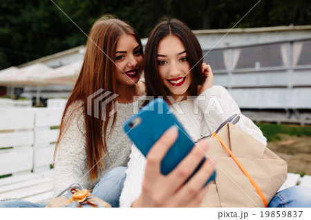 Two girls make selfie with gifts 19859837