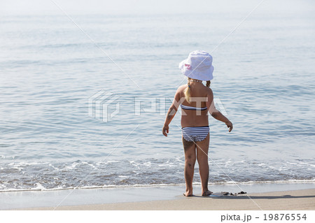 girl standing by the water's edge 19876554