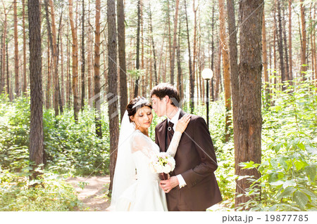 wedding couple hugging, the bride holding a wedding couple hugging, the bride holding a 19877785