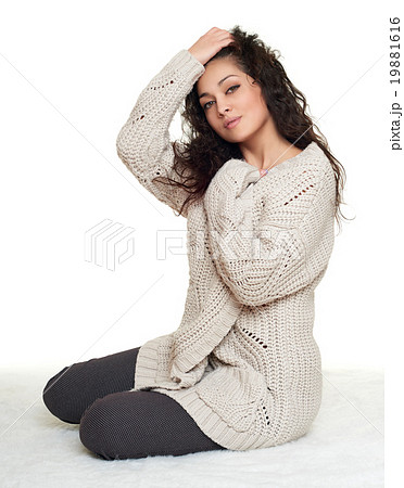 girl portrait in homelike dress sit on fur floor, white background 19881616