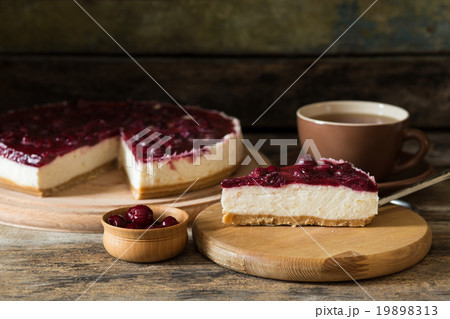 Slice of cheesecake with cup of tea on the table Slice of cheesecake with cup of tea on the table 19898313