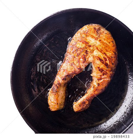 Roasted salmon steak on grill pan on white Roasted salmon steak on grill pan on white 19898433