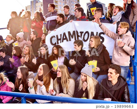 Sport fans holding champion banner on tribunes. 19899663