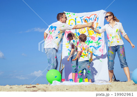 Happy family playing on the beach at the day time. Happy family playing on the beach at the day time. 19902961