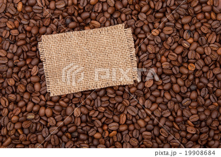 Burlap tag on the background of coffee Burlap tag on the background of coffee 19908684
