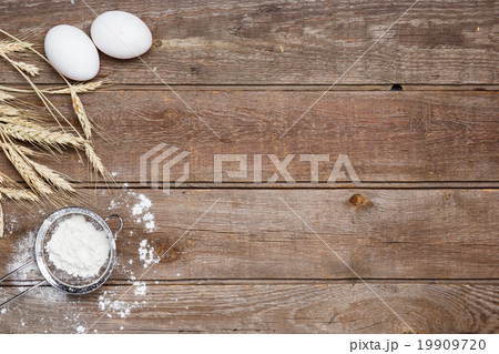 The flour  and eggs on an wooden background 19909720
