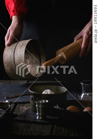 Female hands with wooden rolling-pin and sieve Female hands with wooden rolling-pin and sieve 19913693