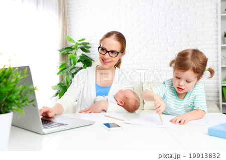 business mother works at home via the Internet with their child business mother works at home via the Internet with their child 19913832