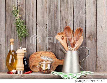 Kitchen utensils, herbs and spices on shelf 19914049