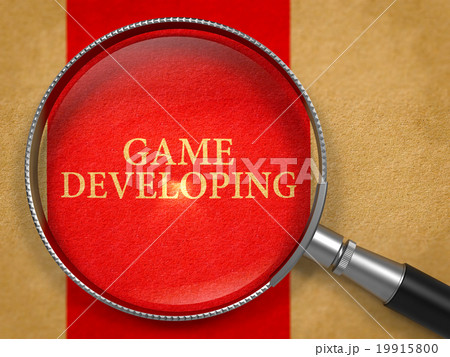 Game Developing through Loupe on Old Paper. 19915800