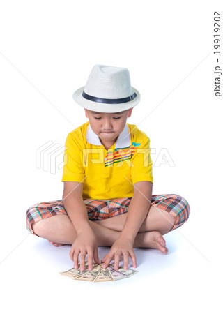 Asian child holding money while standing isolated 19919202
