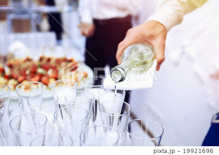 Waiter pours white wine in wineglass Waiter pours white wine in wineglass 19921696