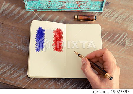 Woman hand drawing France flag on notebook Woman hand drawing France flag on notebook 19922398